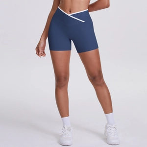 Detail view of high waist yoga shorts featuring a contrast white V-shaped crossover waistband