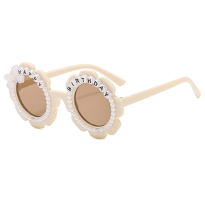 Cream flower-shaped kids' birthday sunglasses with pearls and Happy Birthday text