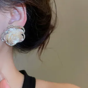 Elegant white camellia stud earring with resin petals and shimmering diamond border