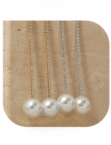 Detail shot of elegant long tassel earrings with gold and silver chains and pearls