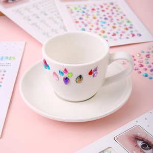 Detailed view of colorful teardrop and heart gems on a white ceramic plate
