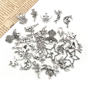 Detailed macro view of antique silver angel charms with engraved inspirational quotes