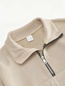 Close-up of zipper stand collar and fabric texture of men's beige knitted pullover
