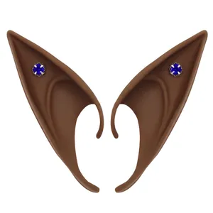 Detail of coffee brown latex elf ears featuring blue gemstones in silver claw settings
