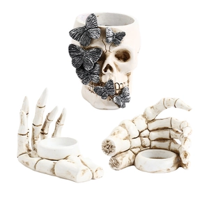 Gothic skull container with butterfly detail and skeletal hand candle holders set