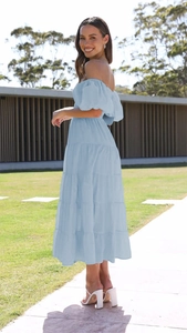 Detail view of light blue off-shoulder dress featuring tiered skirt and puff sleeves