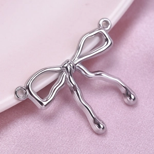 Macro shot of silver bow pendant made of 304 stainless steel with polished finish