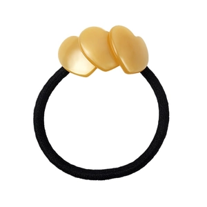 Detail shot of heart-shaped gold resin charms on a black elastic ponytail holder