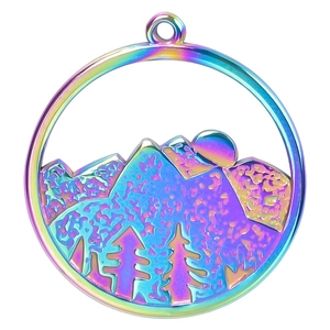 Macro shot of iridescent rainbow stainless steel round pendant with mountain landscape design
