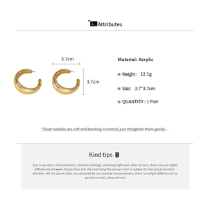 Detail of gold C-shaped acrylic hoop earrings showing 3.7cm size and silver pins