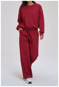 Detail view of burgundy knitted wide-leg track pants with adjustable drawstring waist
