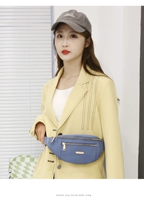 Blue textured multi-layer waist bag worn over a yellow blazer with metal zippers