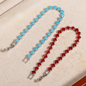 Close-up of star-shaped beaded bracelets in pink and blue with polished metal clasps