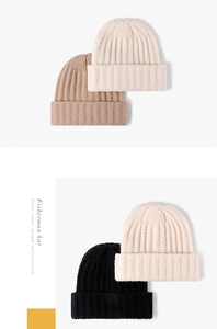 Close-up of thick ribbed knit texture on a beige fisherman beanie for winter warmth