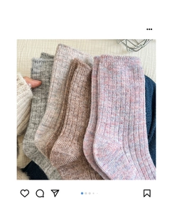 Close-up of thick gradient wool socks in grey, beige and brown showing soft texture