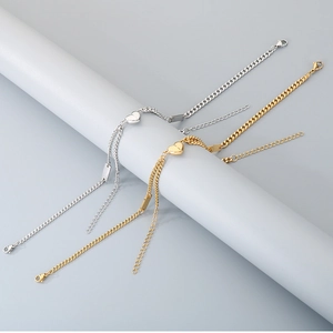 Detail of heart magnet connectors on gold and silver stainless steel couple bracelets
