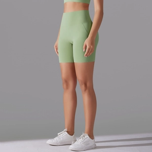 Side view of high-waisted pale green yoga shorts with wide waistband and butt-lifting effect