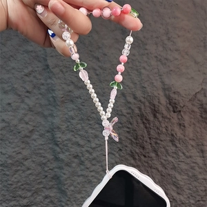 Detail of pink tulip beaded phone strap with pearls and a delicate bow charm