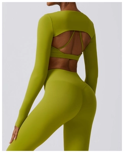 Detail of green backless yoga top with cutout design and matching high waist leggings