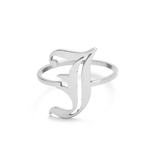 Macro view of silver vintage gothic letter J ring with polished metallic finish