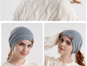 Detail view of grey knit beanie with ponytail hole showing warm texture and fit