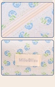 Detail of blue floral lace material with fine stitching and creative woven label