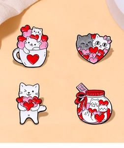 Detail of four creative cat and heart enamel pins with Full of Love text on cute badges