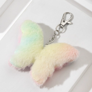 Pastel gradient plush butterfly keychain with silver metal clasp on white stand