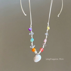 Detail of colorful beads and white seashell pendant on 70cm wax cord necklace