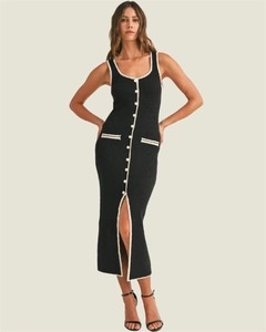 Close-up of slim-fit knitted dress featuring white contrast piping and button detailing