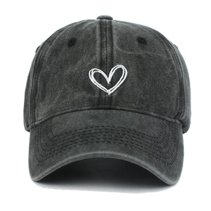 Detailed view of white heart embroidery on washed cotton vintage baseball cap