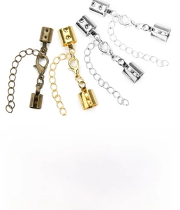 Detail view of copper cord end caps and lobster clasps in various plating finishes