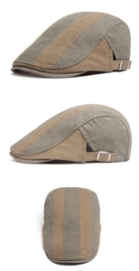 Detail of grey-green patchwork cotton beret cap with metal buckle and fabric texture