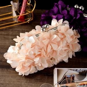 Detail of pink floral evening clutch bag with 3D petals and silver metal clasp