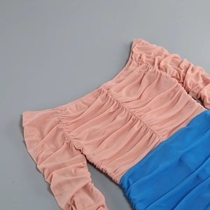 Detailed close-up of pleated mesh fabric with orange and royal blue color block design