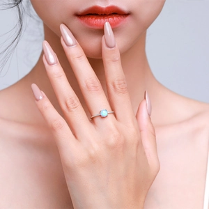 Minimalist S925 sterling silver ring featuring a blue opal gemstone on a model hand