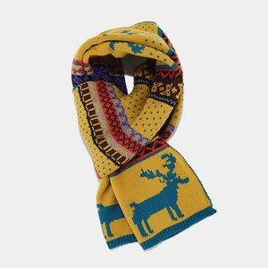 Detailed knit pattern of yellow winter scarf featuring blue reindeer and geometric motifs
