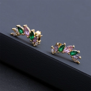 Macro shot of 18K gold geometric earrings with colorful marquise-cut zircons on a leather stand