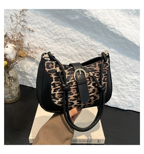 Detail of leopard print shoulder bag with knotted strap and golden metal buckle