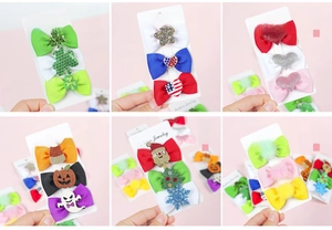 Detailed set of holiday bow hair clips featuring festive ribbons and seasonal decorations