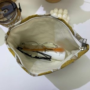 Internal layout of yellow mushroom jacquard travel pouch with cosmetics and accessories