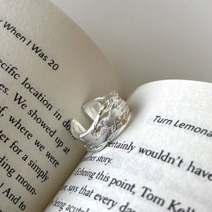Artistic S925 silver ring with lava texture and gold beads tucked in book pages