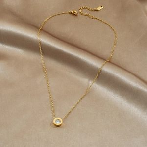 Minimalist gold stainless steel necklace with Roman numeral disc and zircon on silk