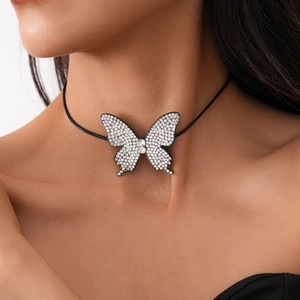 Close-up of a sparkling crystal butterfly choker necklace worn on a woman's neck