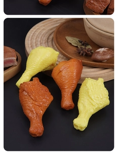 Realistic PVC chicken drumstick model with spices on a wooden tray for decoration