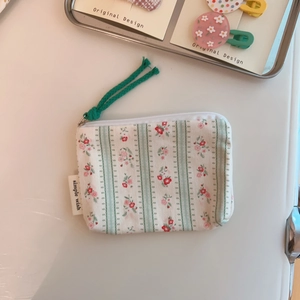 Macro view of floral pattern cotton coin purse with zipper and simple wish label