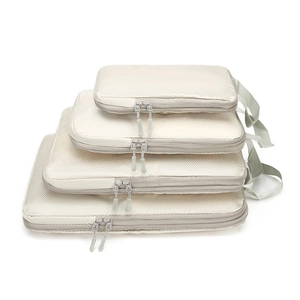 4-piece set of beige compression travel organizers in varying sizes with mesh design