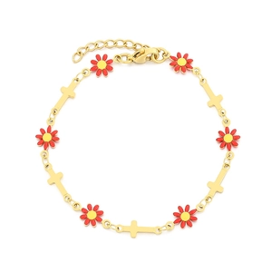 Golden daisy and cross charm bracelet with red floral petals and yellow pistils on white background