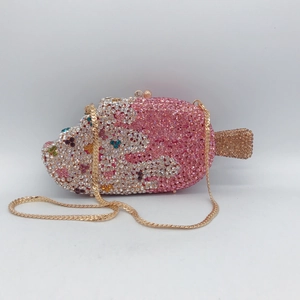 Close-up of pink ice cream evening bag featuring sparkling crystals and gold chain strap
