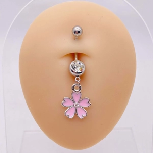 Detailed view of pink cherry blossom navel ring with crystals on a skin model